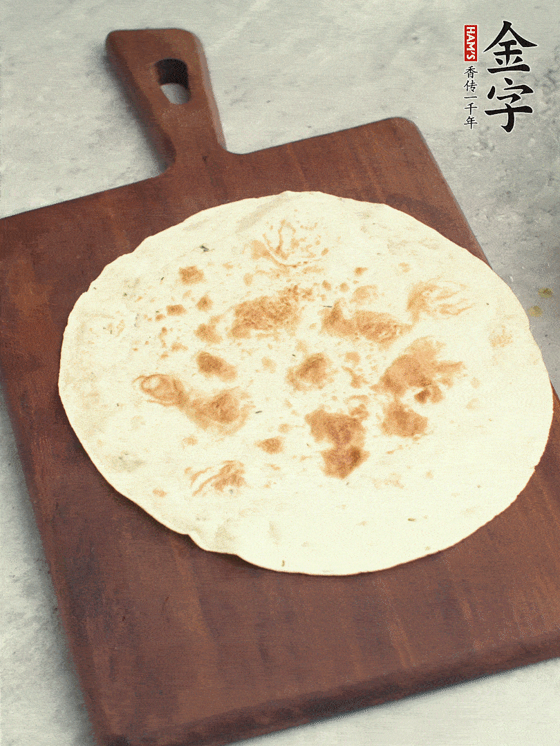 食材依次鋪在卷餅皮上，卷起來(lái)。